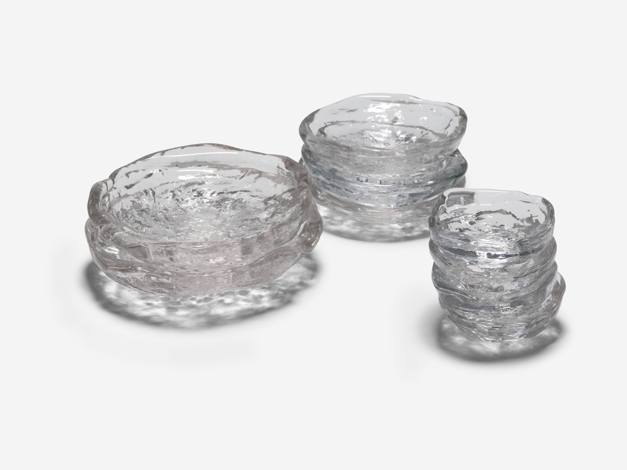 Three different sized glass bowls stacked front angle view